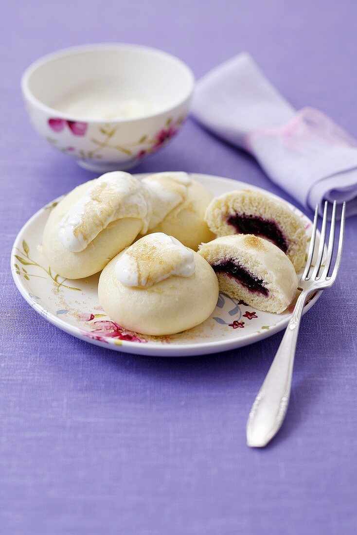 Steamed yeast dumplings with blackberry filling & whipped cream
