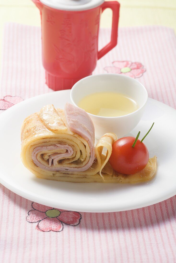 Ham crêpes and tomato snail with tomato stock
