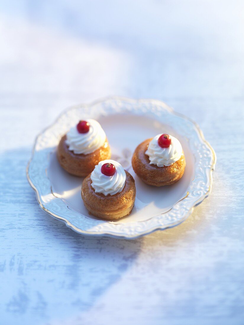 Small babas with cream rosettes and redcurrants