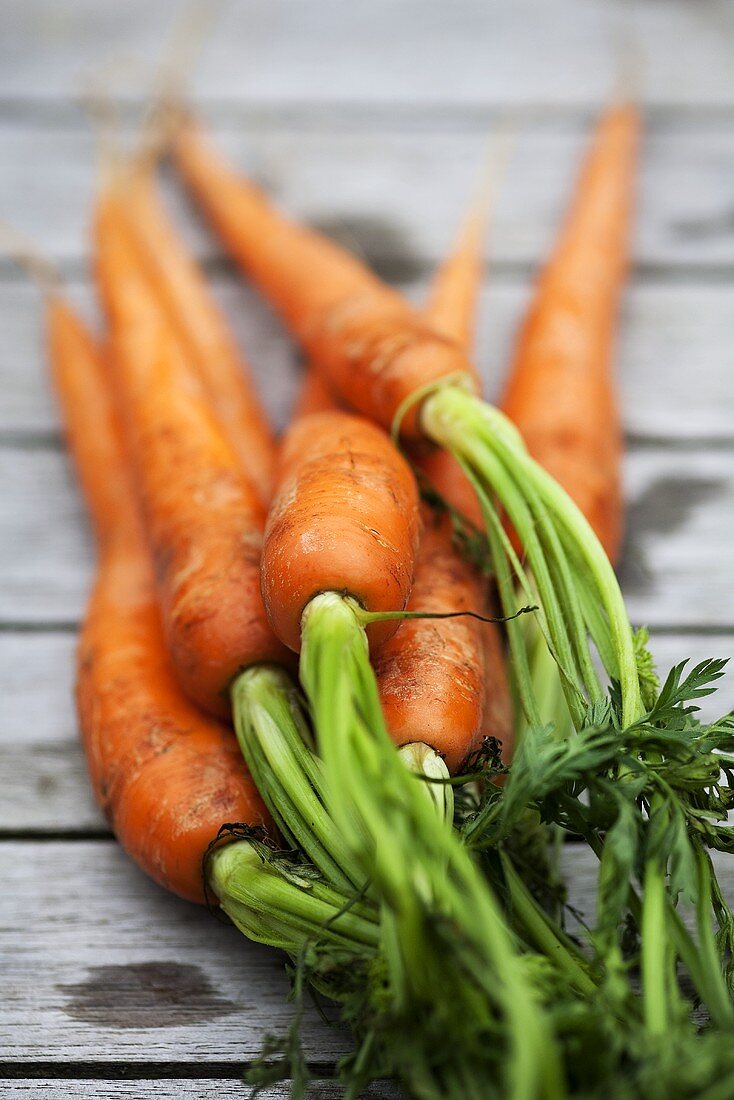 Fresh carrots on wooden table