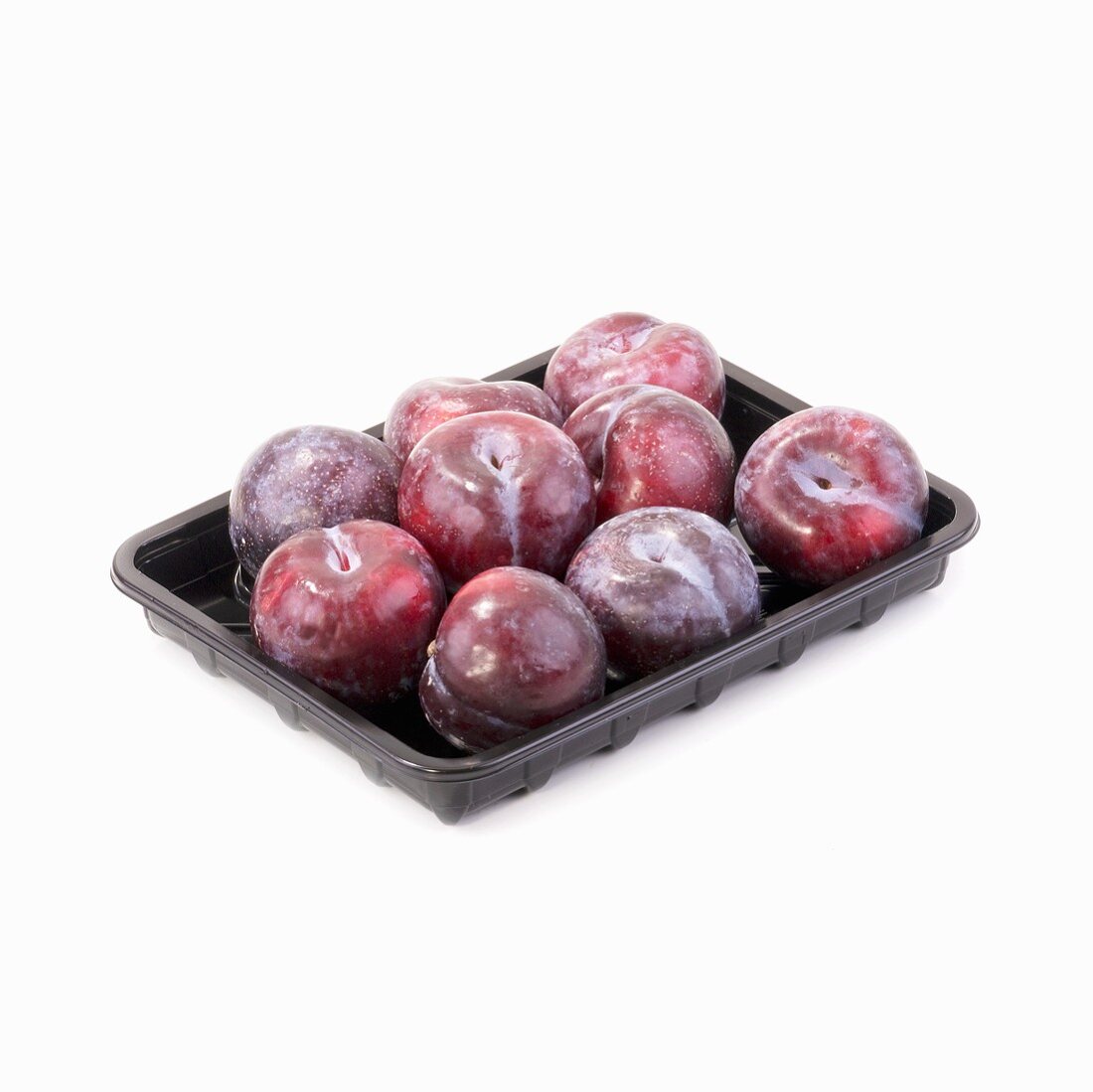 Plums in a plastic tray