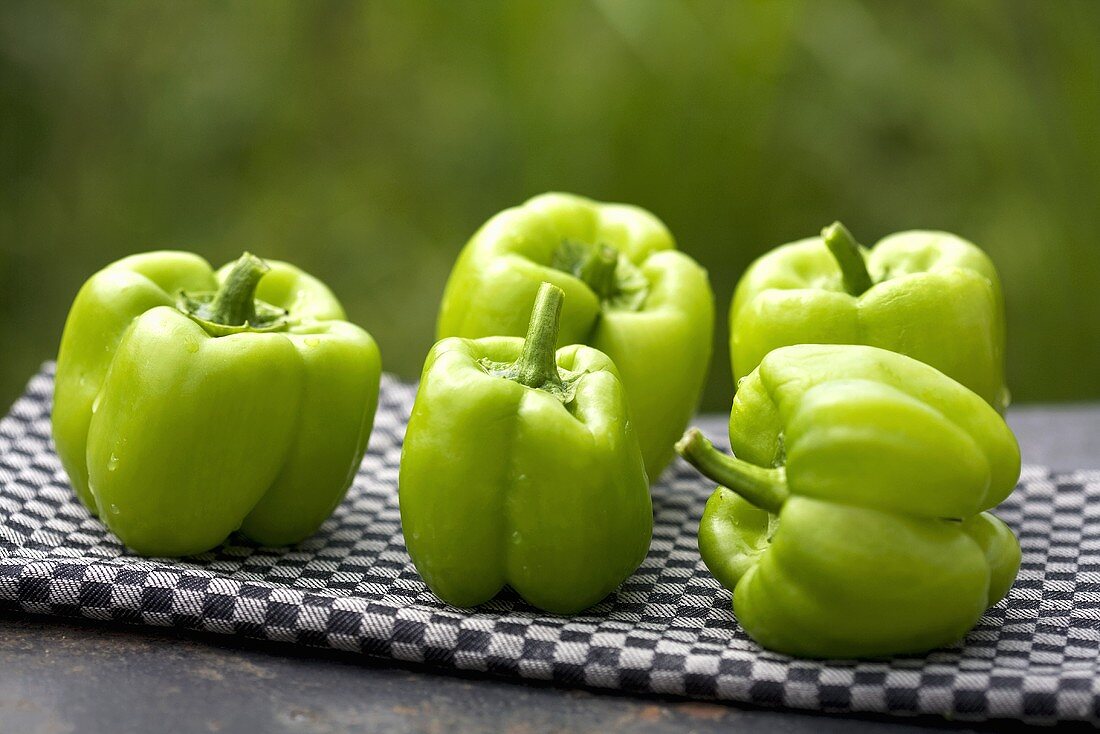 Green peppers on a tea towel