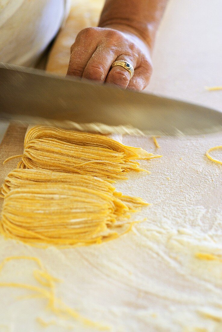 Making tajarin (thin egg pasta, Italy)