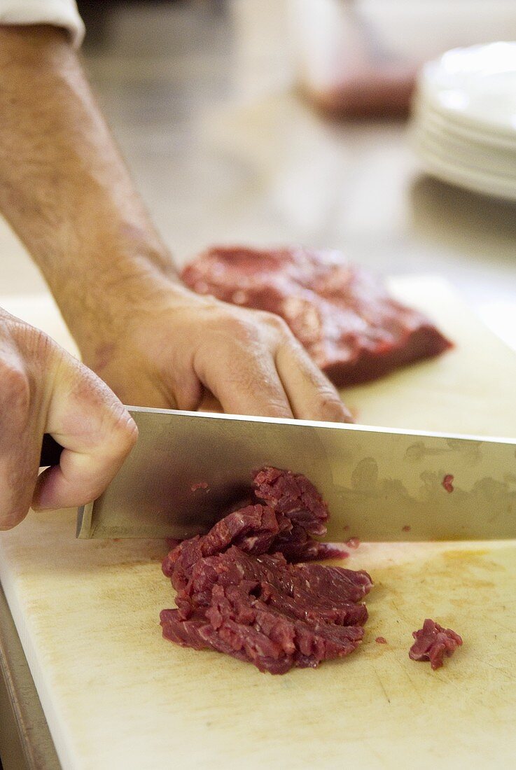 Cutting veal into small pieces (for carne cruda)