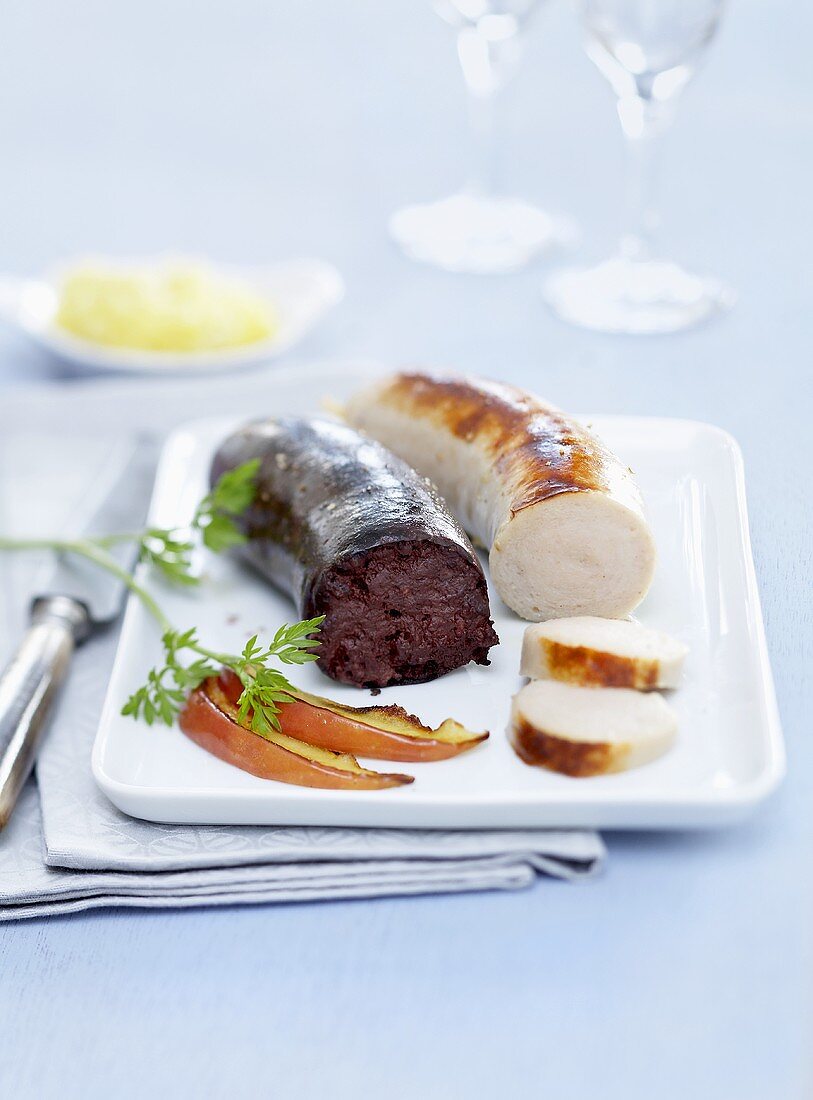 Black pudding and white sausage with mashed potato and apple