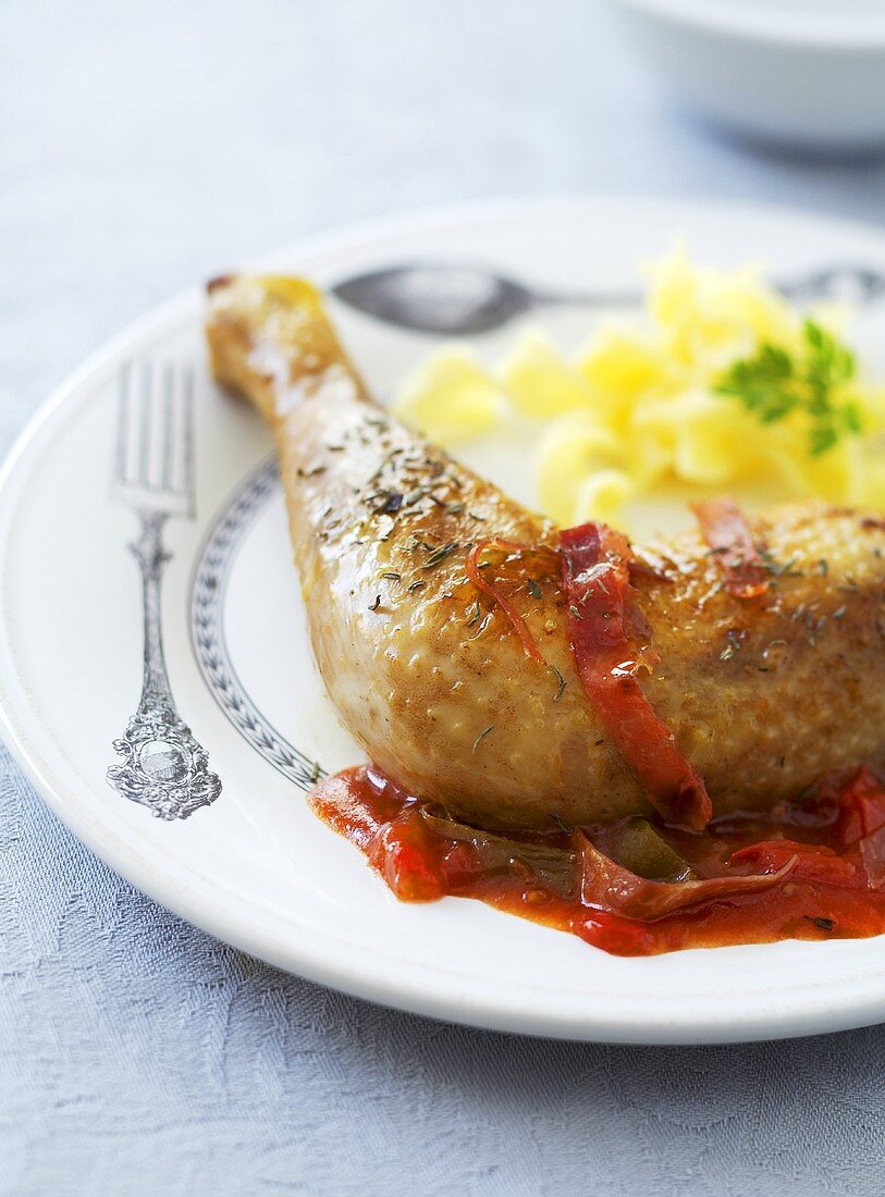 Chicken leg with tomato and pepper sauce