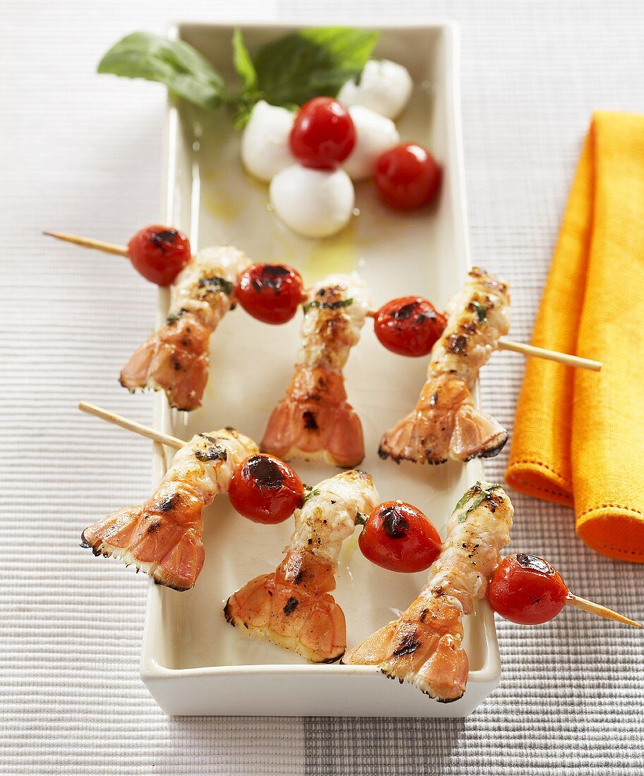 Scampi and cherry tomatoes on wooden skewers