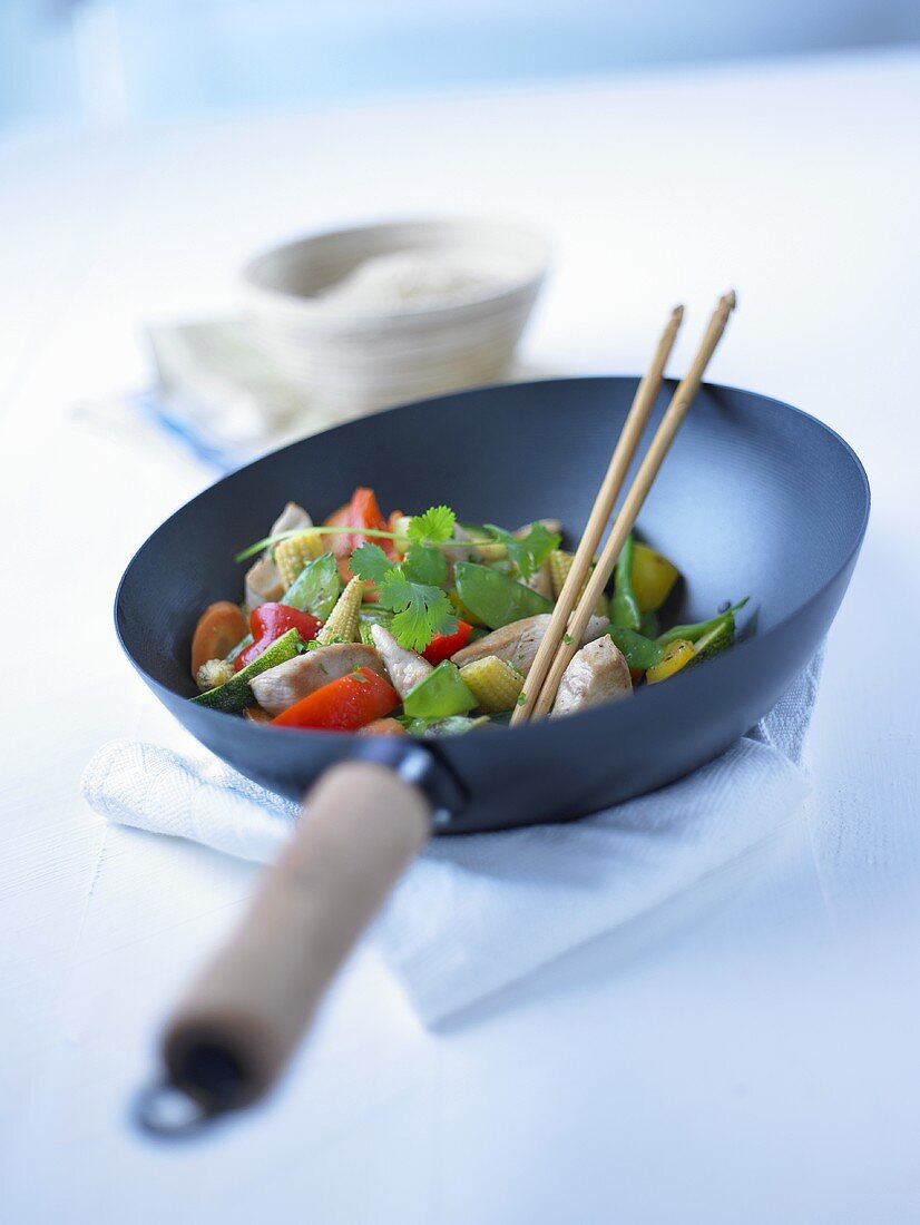 Meat, vegetables and fresh coriander in wok