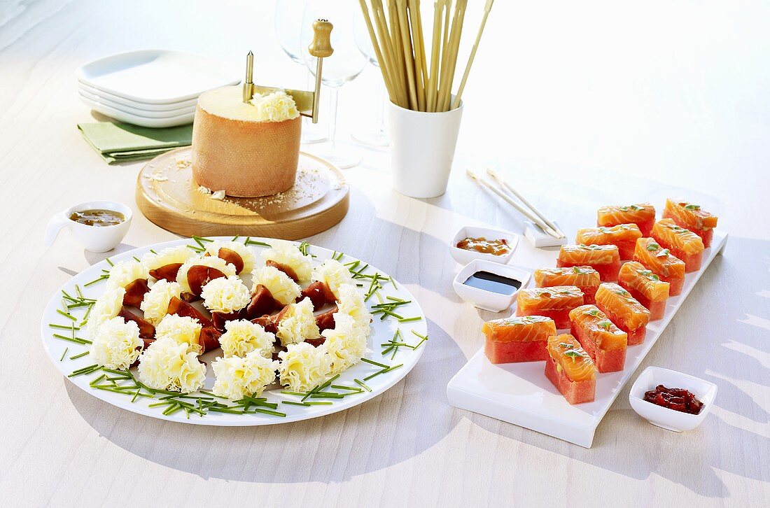 Cheese flowers with Bündnerfleisch, salmon sashimi with watermelon