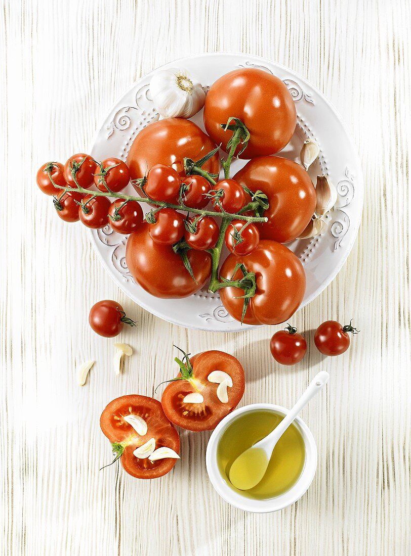 Tomatoes prepared for grilling with olive oil and garlic