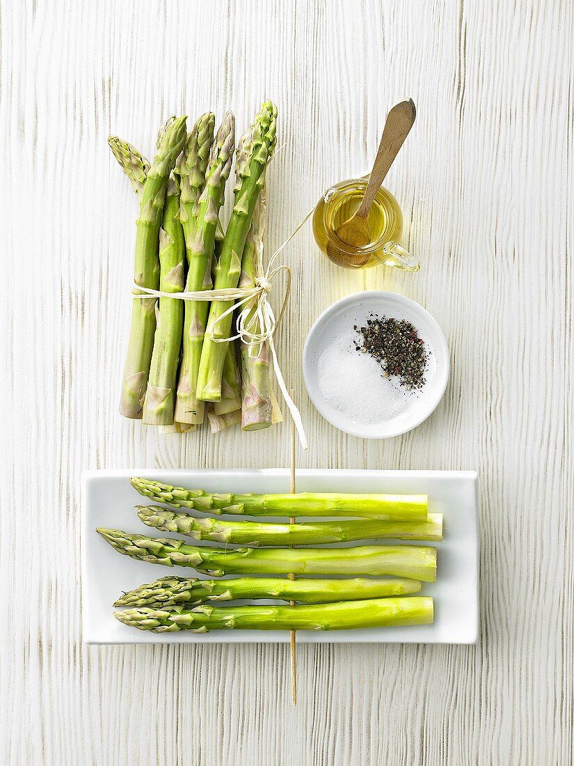 Green asparagus with seasonings & olive oil before grilling