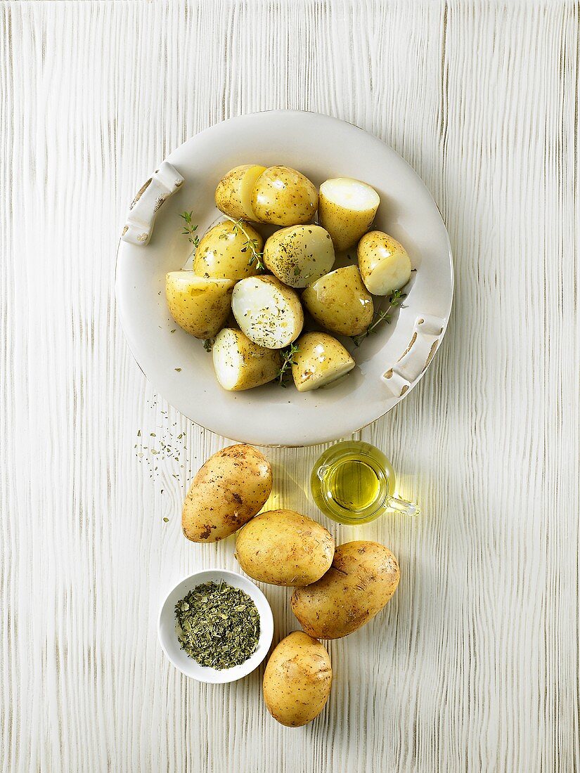 Potatoes sprinkled with olive oil & herbs ready for grilling