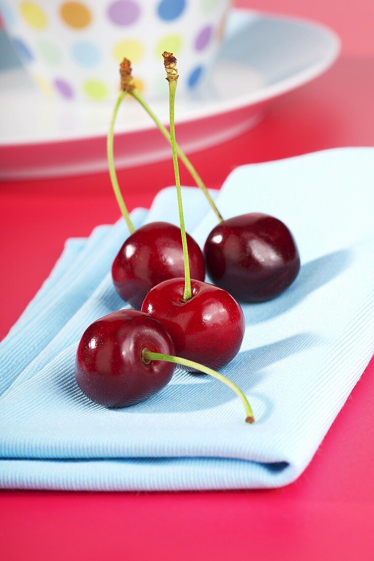 Cherries on blue napkin