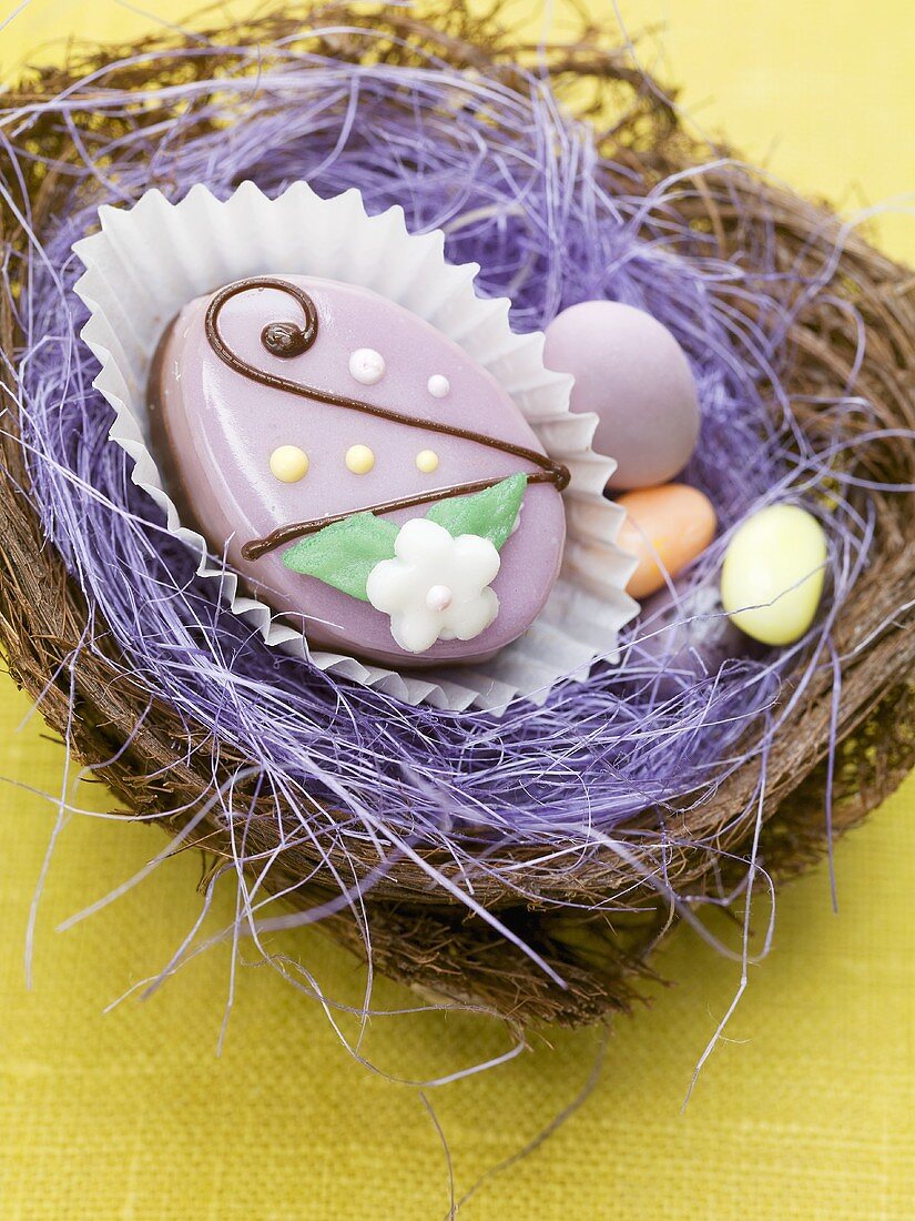 Petit four and sugar eggs in an Easter nest