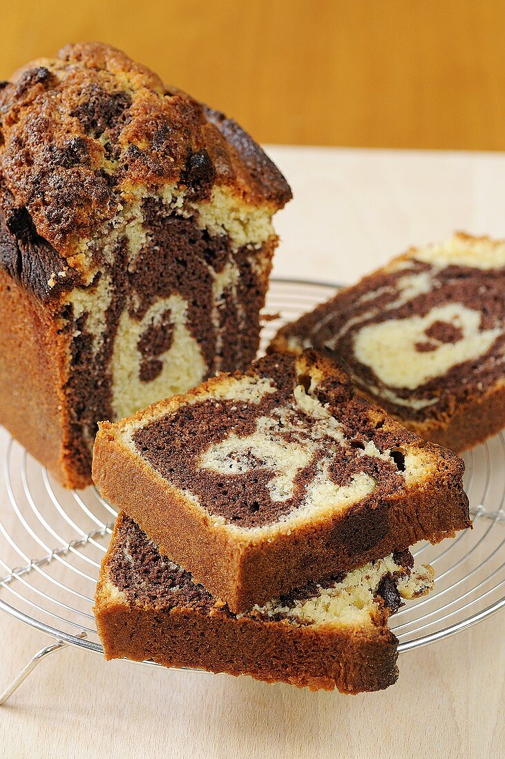 Marble cake, partly sliced on a cake rack