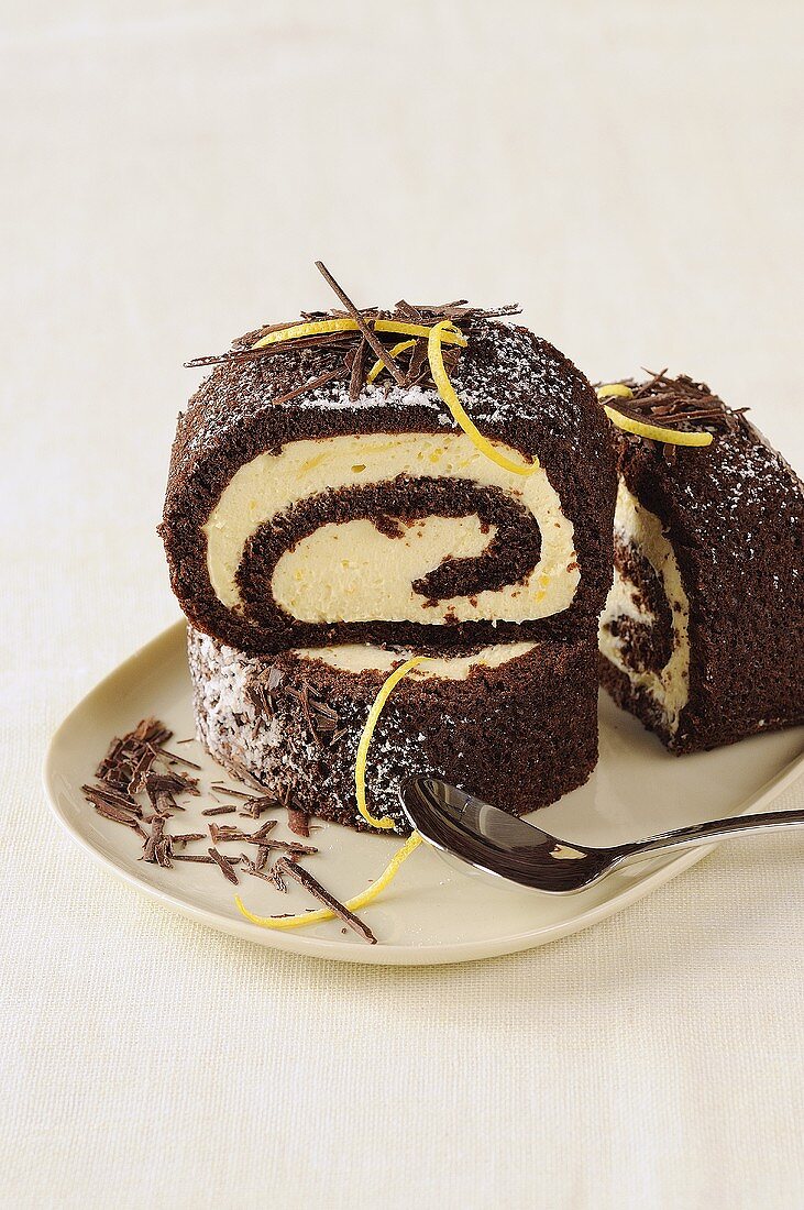 Slices of chocolate Swiss roll with lemon curd filling