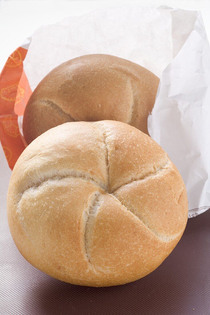 Two bread rolls with paper bag