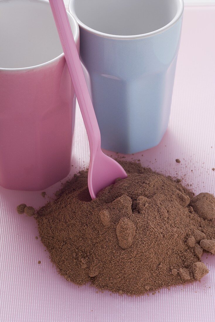 Drinking chocolate and beakers on pink background
