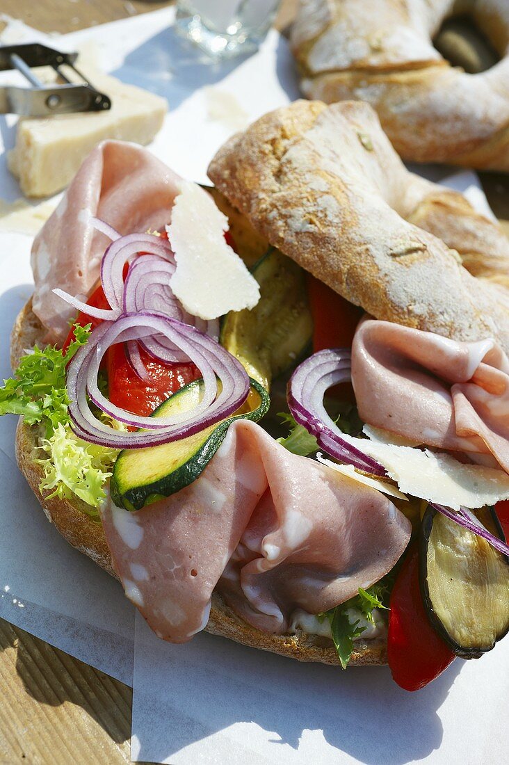 Bagel filled with mortadella and antipasto vegetables