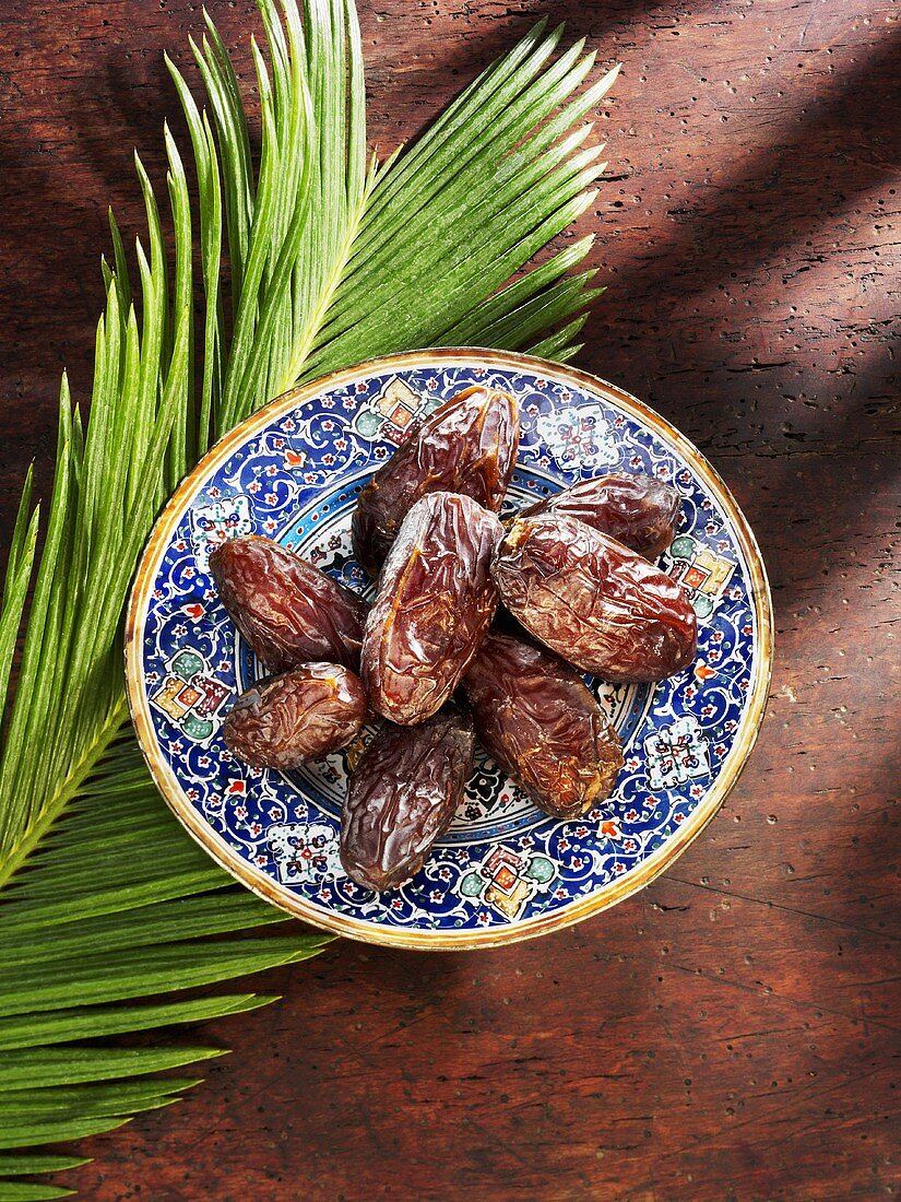 Dates on plate and palm leaf
