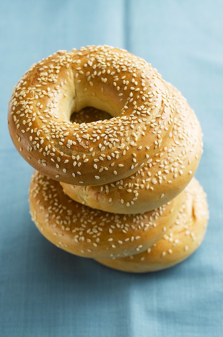 Four sesame bagels, stacked