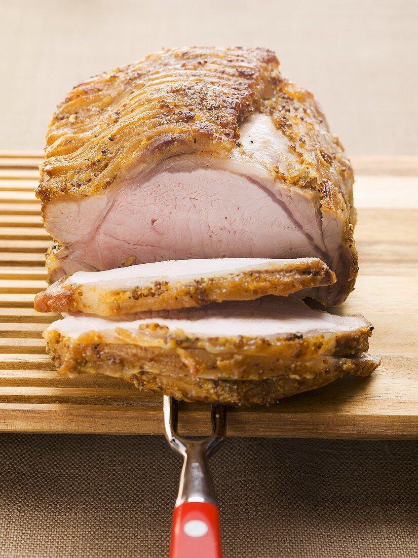 Roast pork with crackling on wooden board