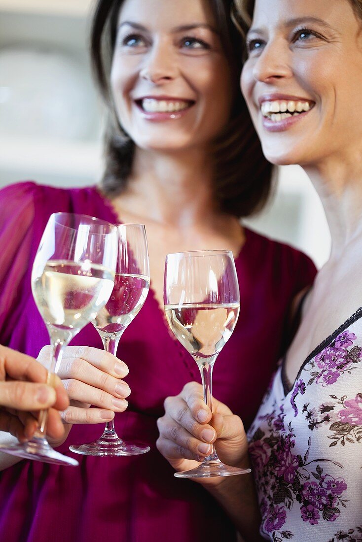 Women with glasses of white wine