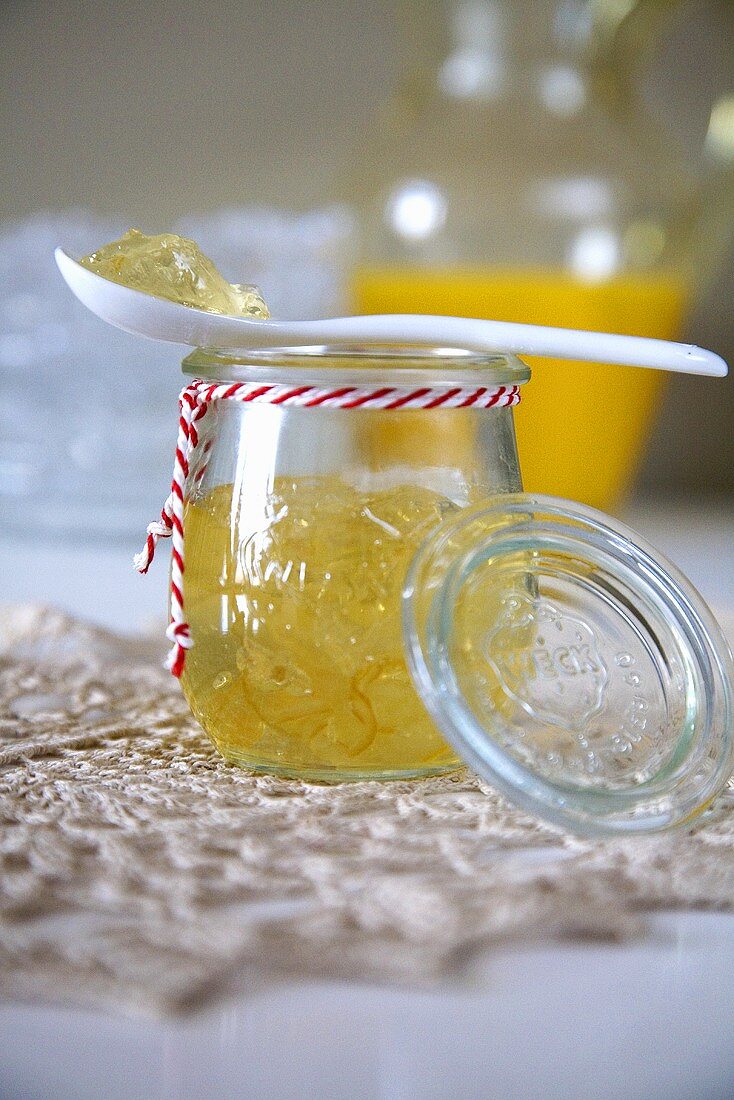 Orange jelly in jar with spoon