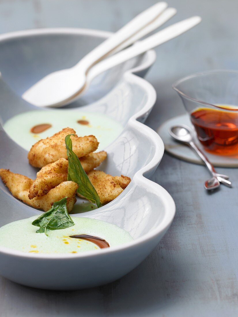 Creamy soup served with mozarella in breadcrumbs
