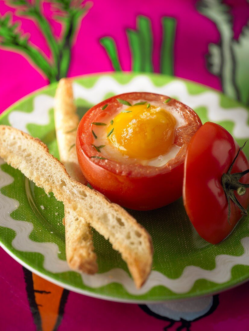 Baked egg in tomato, toast soldiers