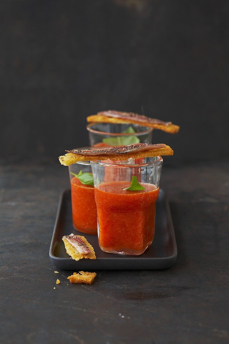Gazpacho in three glasses with anchovy crostini