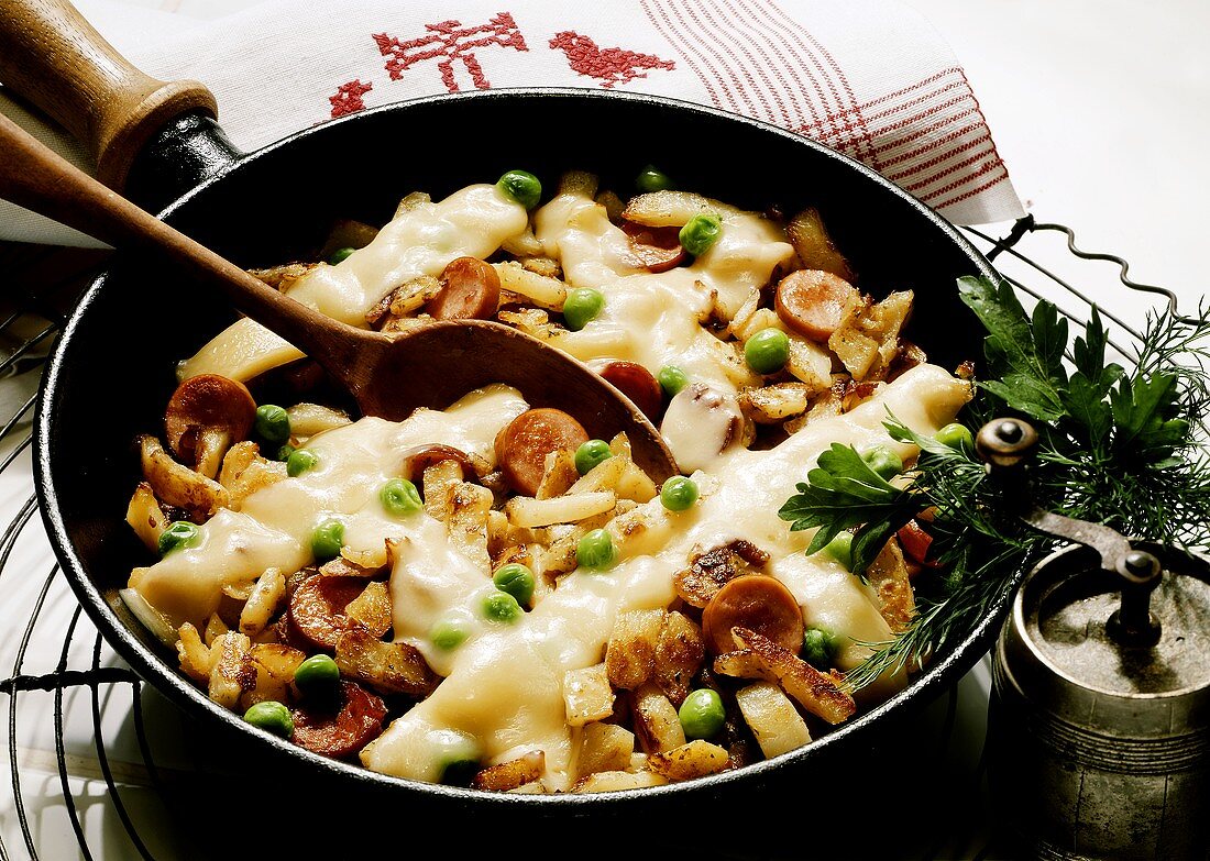 Pan-Fried Stew with Potatoes, Sausage, Peas and Melted Cheese