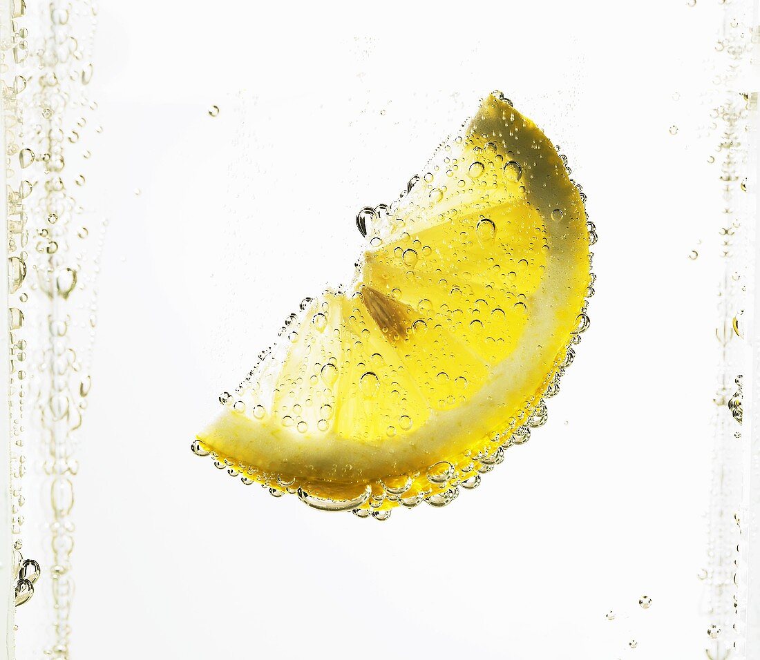 Lemon wedge in mineral water