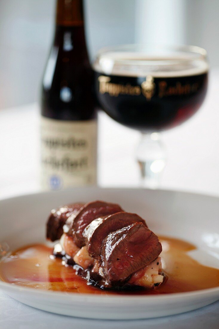 Venison loin fillet on red wine sauce & a glass of dark beer