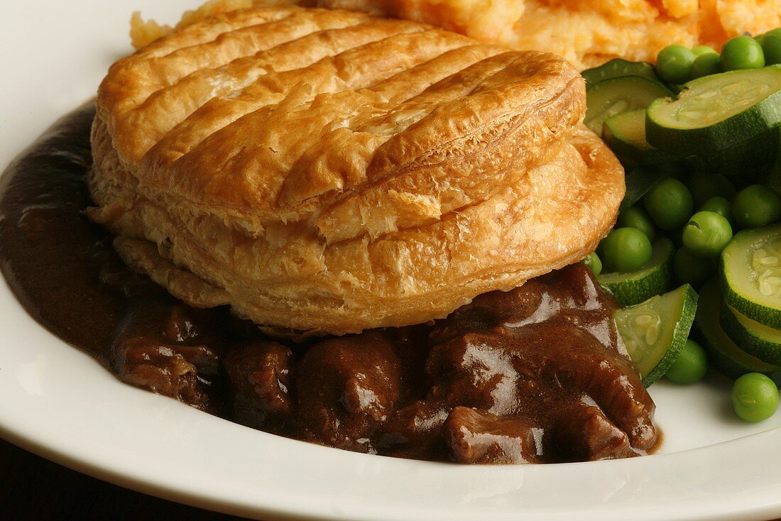 Beef pie with mashed sweet potato and vegetables