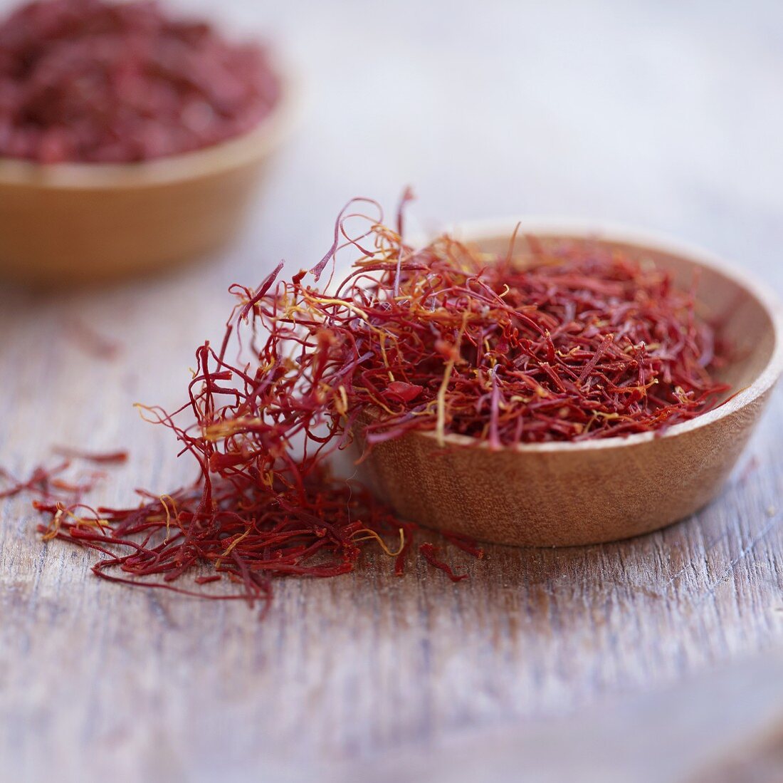 Saffron threads in wooden bowls