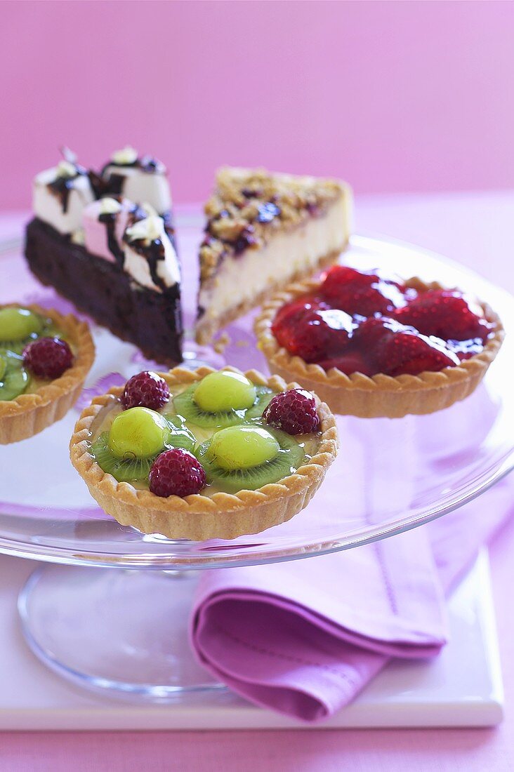 Assorted fruit tartlets and pieces of cake