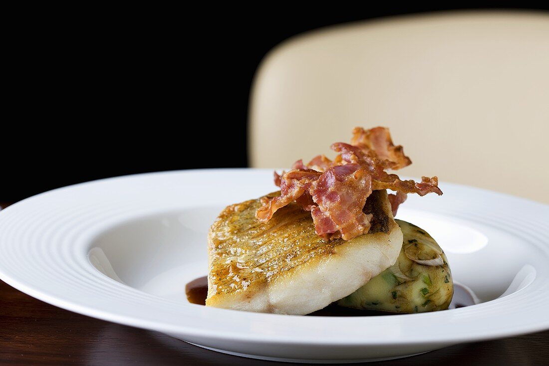Fried sea bass fillet with bacon and mashed potato