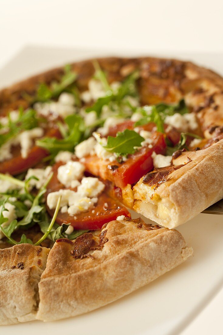 Crusty tomato, ricotta and rocket pizza