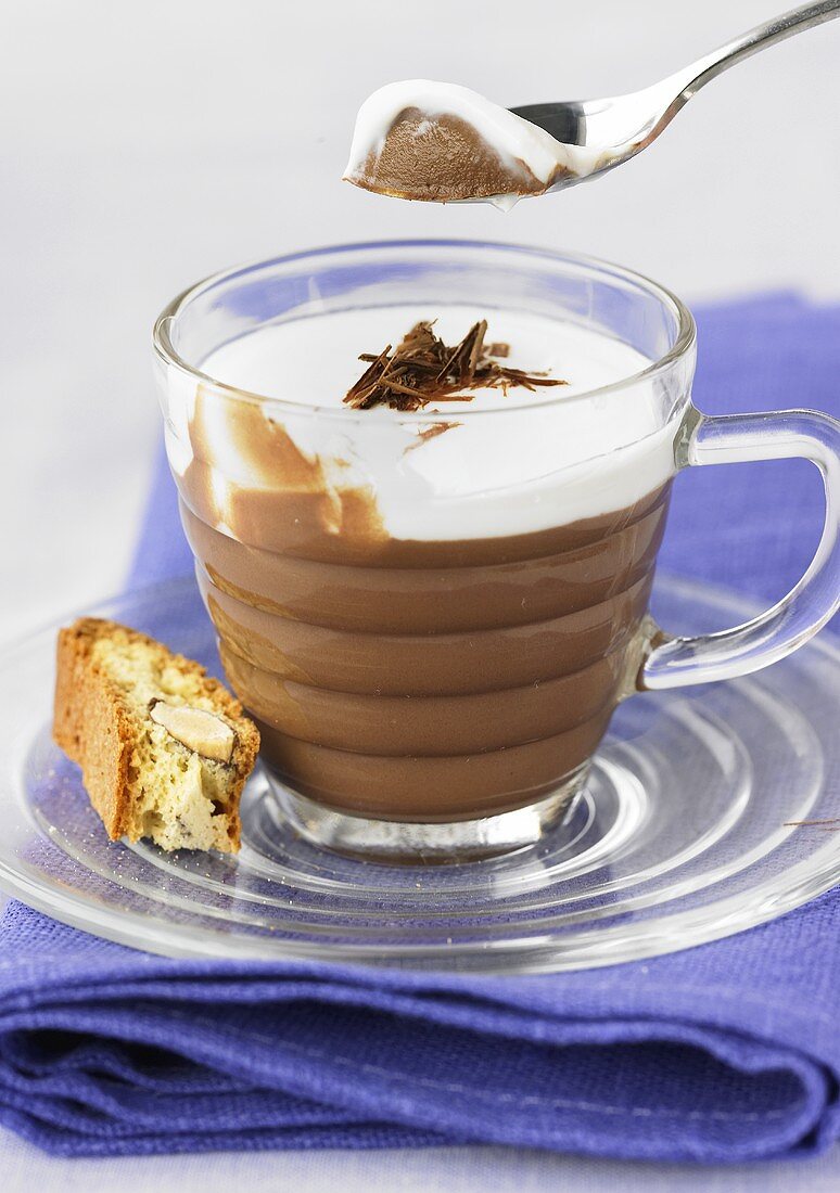 Chocolate mousse with cream topping and cantuccine