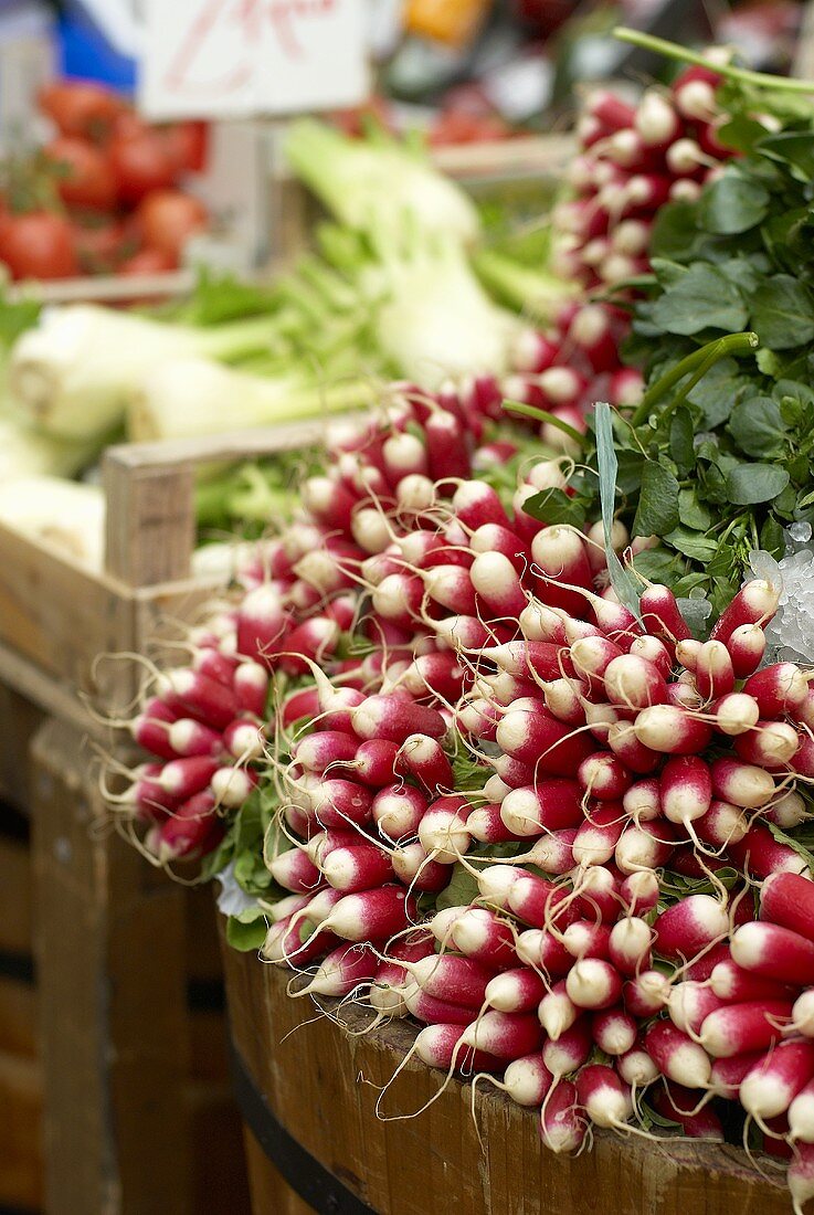 A pile of radishes on a market stall