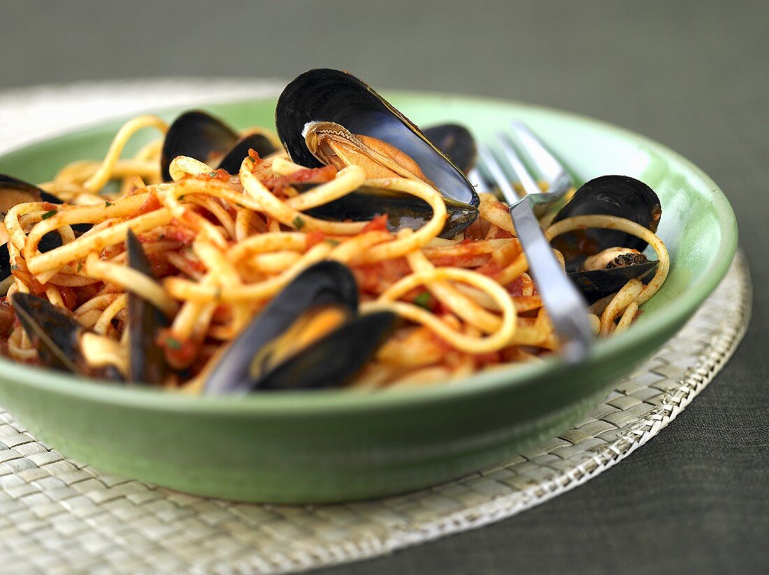 A portion of linguine with mussels and tomatoes