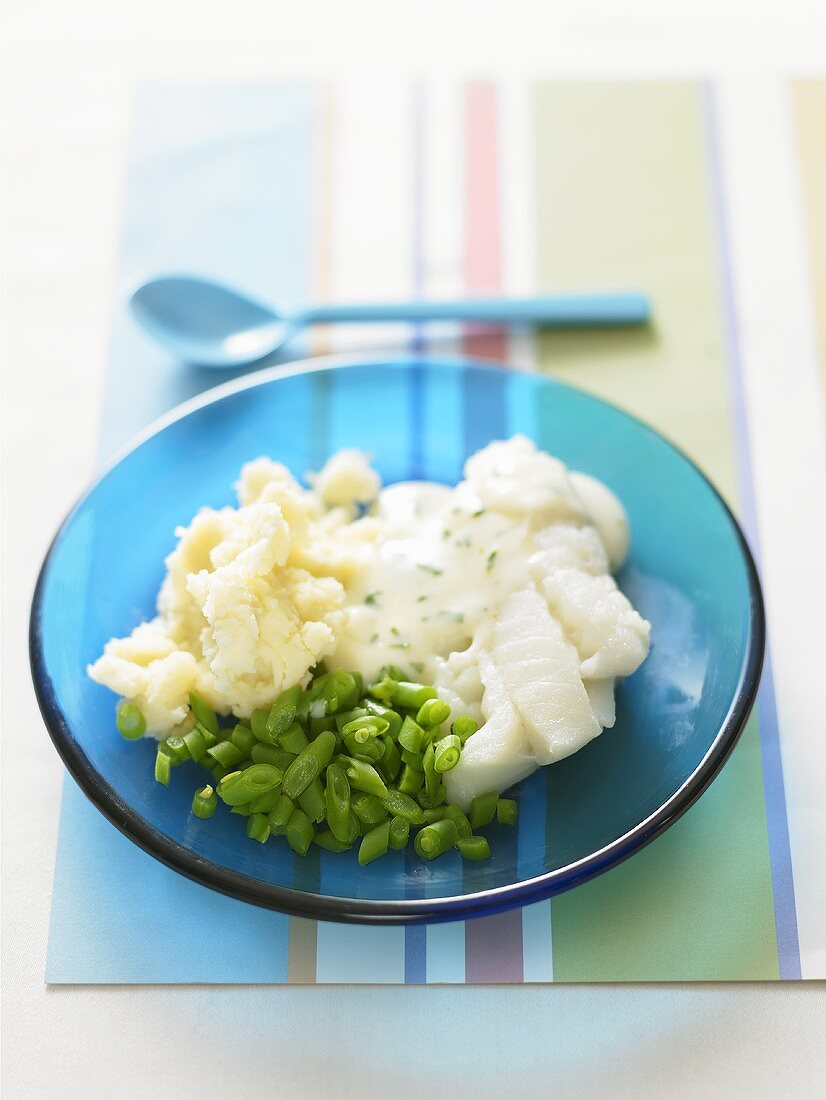 Cod with parsley sauce, mashed potato and beans