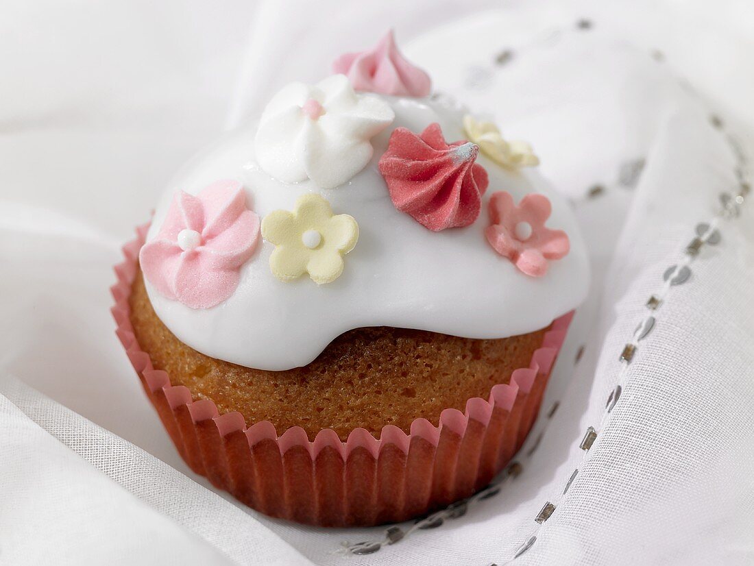 Mit Zuckerblüten verzierter Cupcake zur Hochzeit