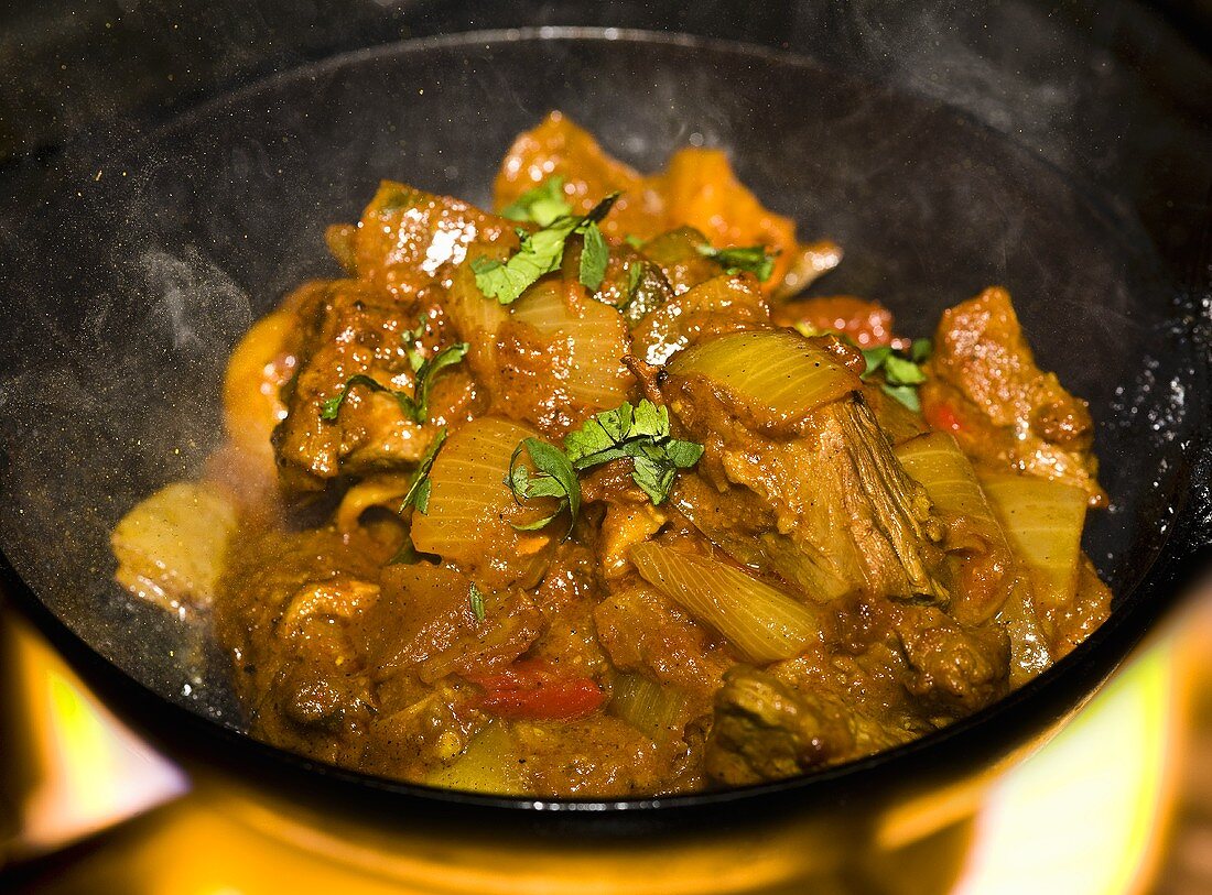 Beef gosht in karahi (Indian cast-iron wok) over fire