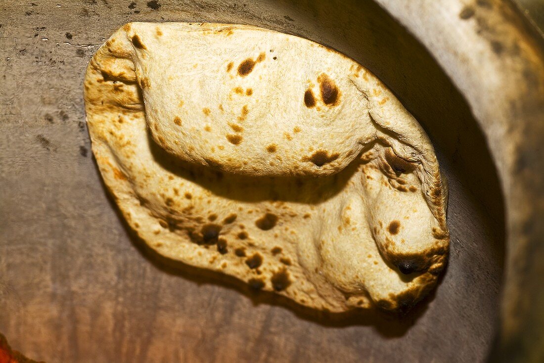 Naan bread in a tandoor