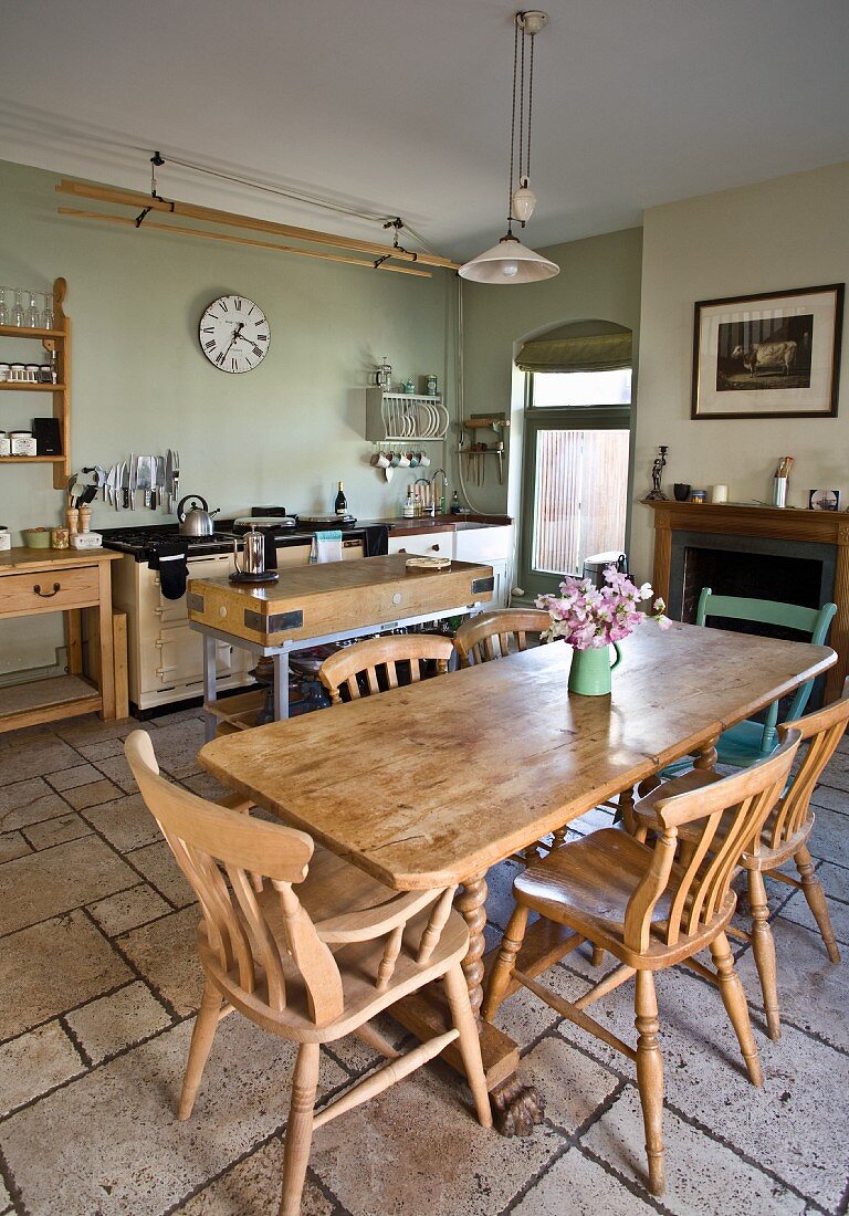 Kitchen with wooden furniture and stone floor