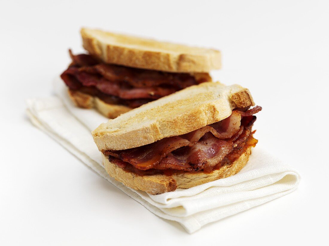 Bacon sandwiches on fabric napkin