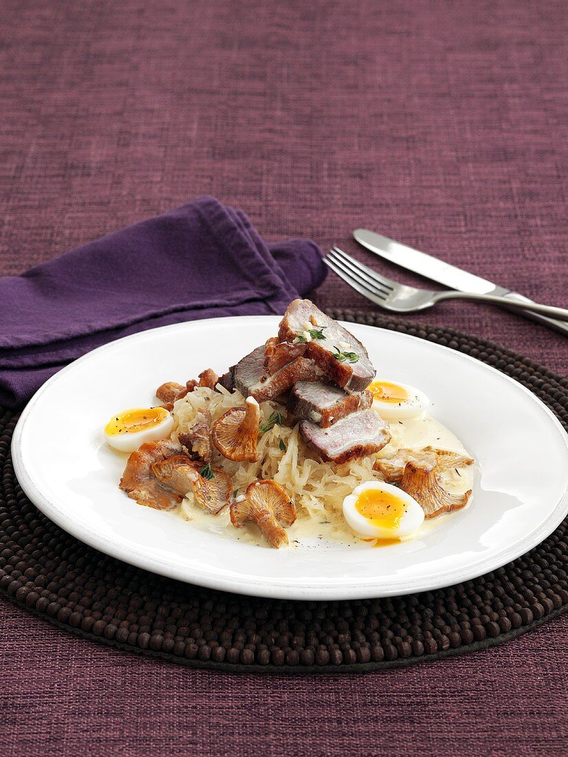 Duck breast on sauerkraut with chanterelles and quail's eggs