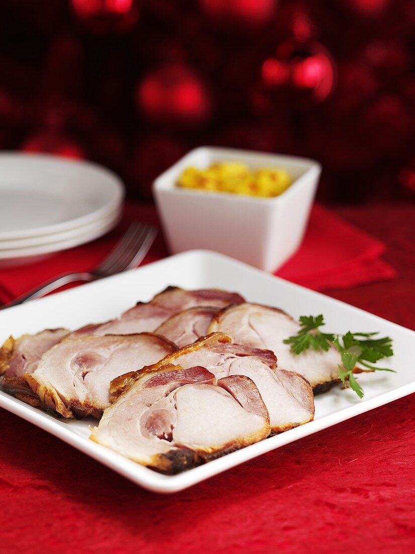 Roast ham on a white plate